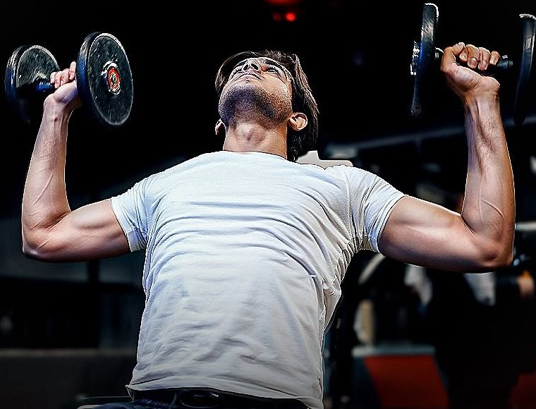 Member lifting dumbbells