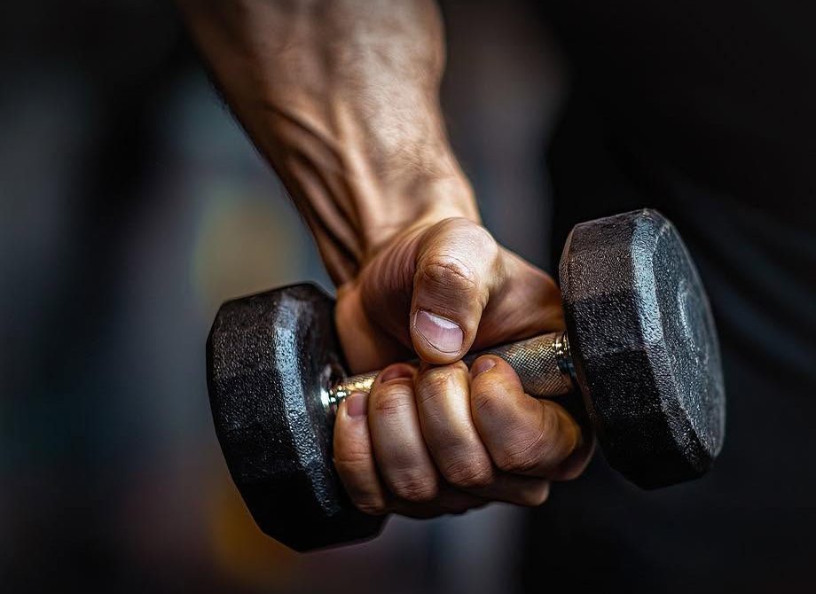 Hand gripping a dumbbell